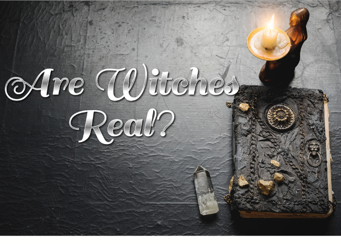 a black table with a journal and a candle with text overlay that says, Are Witches Real?